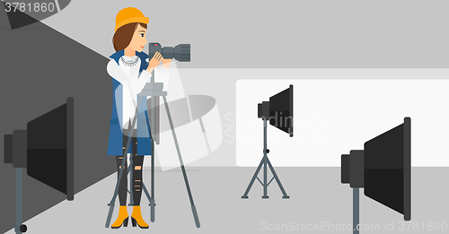 Image of Photographer working with camera on a tripod.