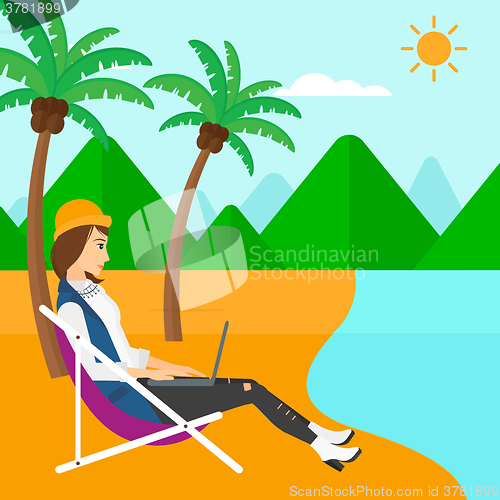 Image of Business woman sitting in chaise lounge with laptop.