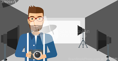 Image of Smiling photographer holding camera.