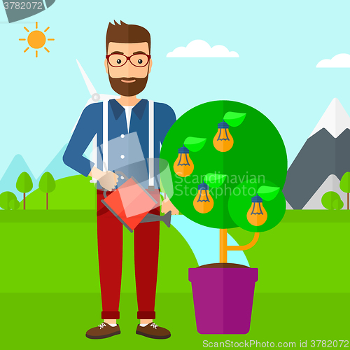 Image of Man watering tree with light bulbs.