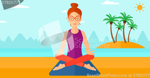 Image of Woman meditating in lotus pose.