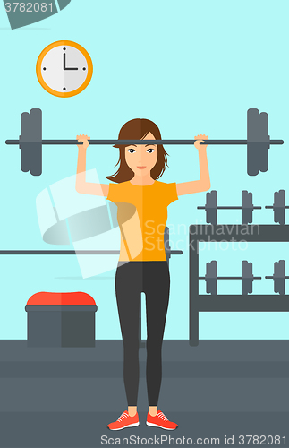 Image of Woman lifting barbell.