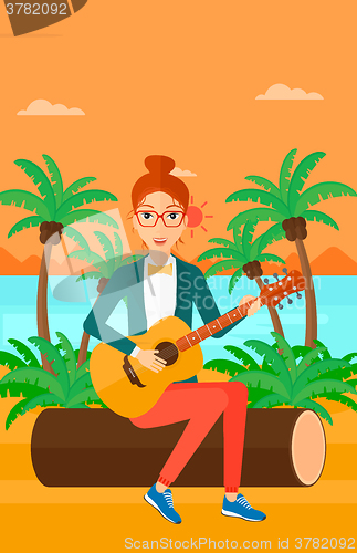 Image of Woman playing guitar.