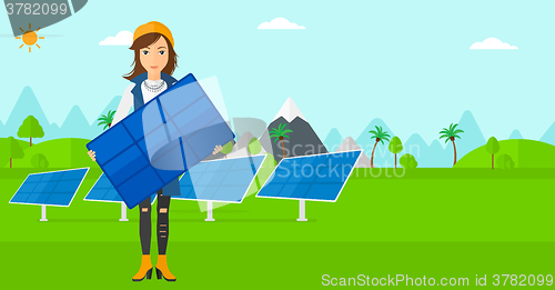Image of Woman holding solar panel.