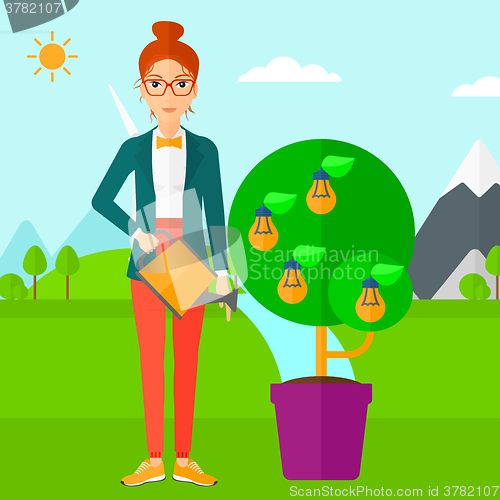 Image of Woman watering tree with light bulbs.