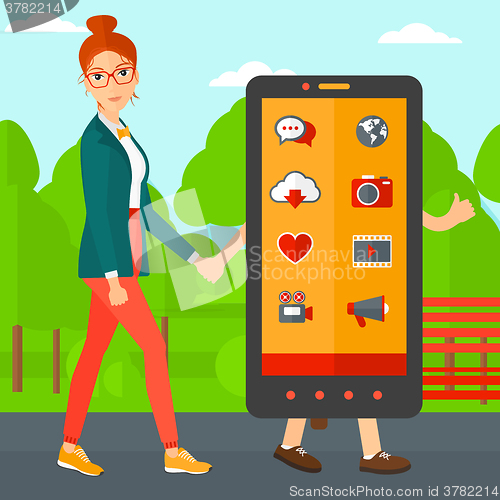 Image of Woman walking with smartphone.