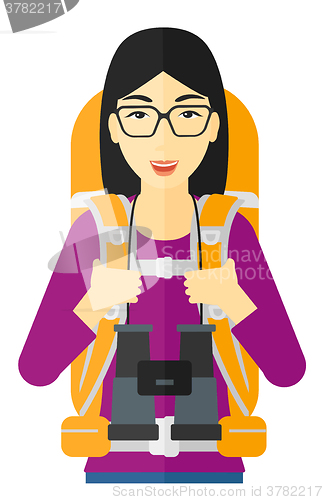 Image of Cheerful backpacker with binoculars.