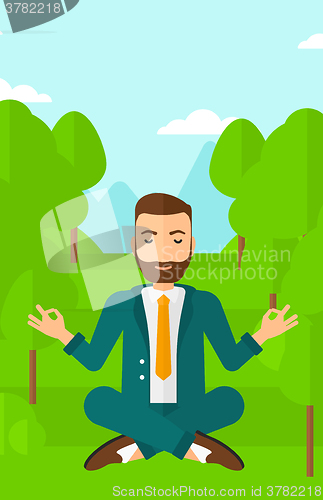 Image of Businessman meditating in lotus pose.