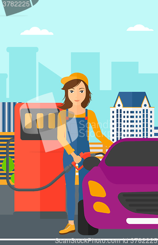 Image of Woman filling up fuel into car.
