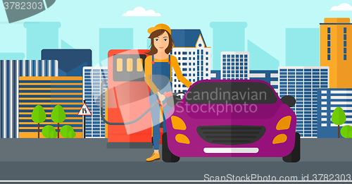 Image of Woman filling up fuel into car.