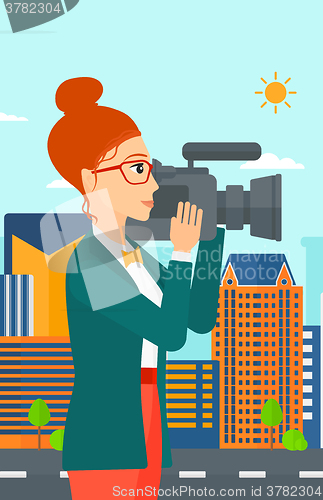 Image of Camerawoman with video camera.