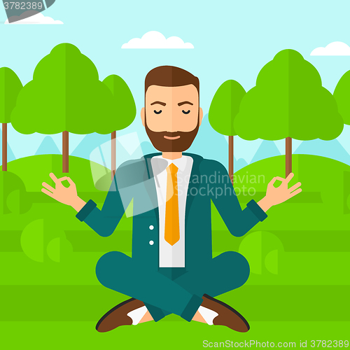 Image of Businessman meditating in lotus pose.