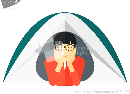 Image of Man lying in tent.