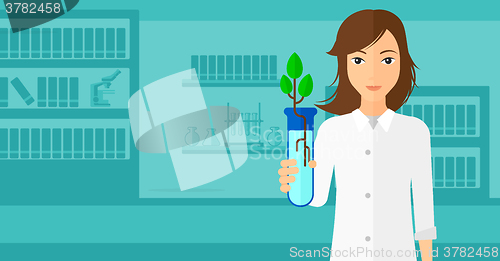 Image of Laboratory assistant with test tube.
