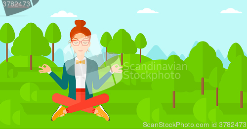 Image of Business woman meditating in lotus pose.