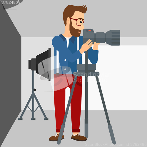 Image of Photographer working with camera on a tripod.