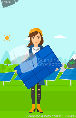 Image of Woman holding solar panel.