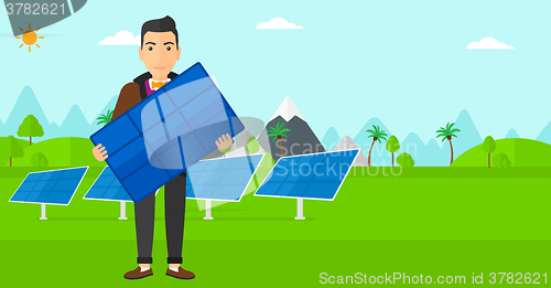 Image of Man holding solar panel.