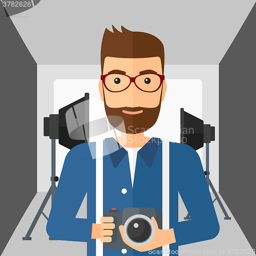 Image of Smiling photographer holding camera.