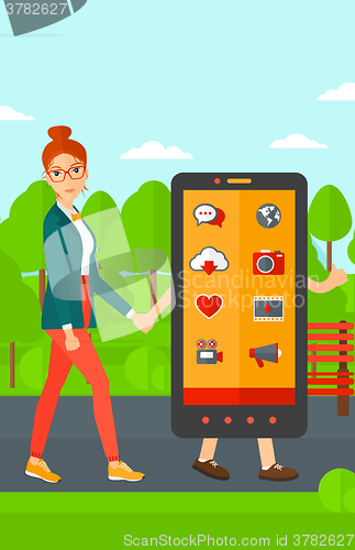 Image of Woman walking with smartphone.