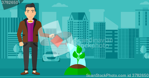 Image of Man watering tree.