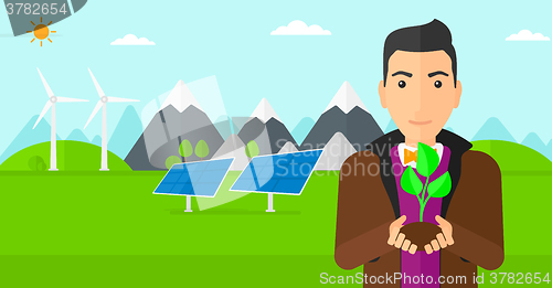 Image of Man holding plant.
