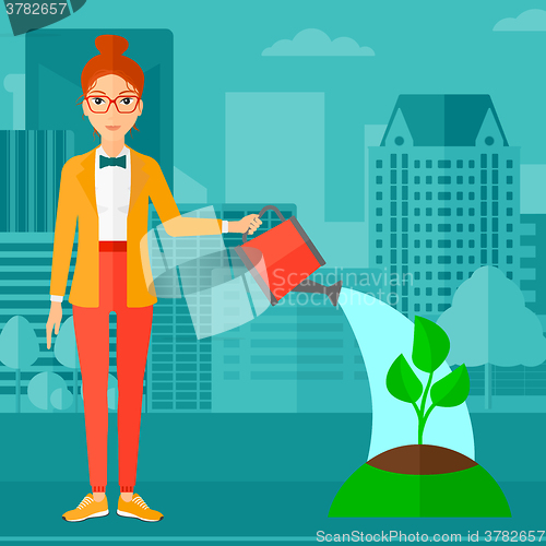 Image of Woman watering tree.