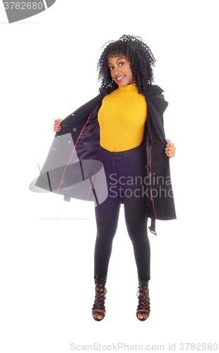 Image of African American woman in yellow sweater and coat.