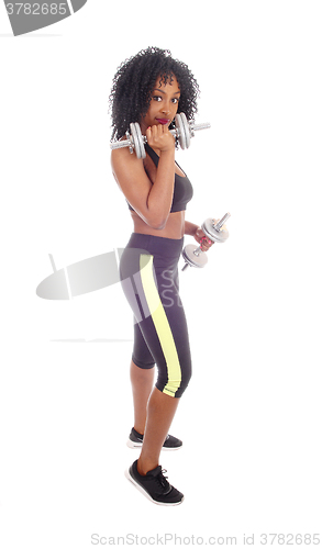 Image of African American woman with dumbbell\'s.