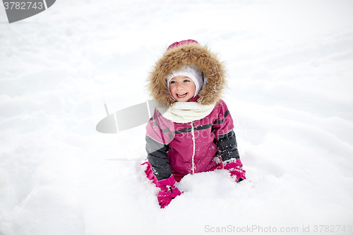 Image of f happy little child or girl with snow in winter