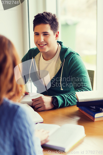 Image of students with books preparing to exam in library