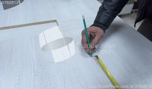 Image of carpenter worker measuring