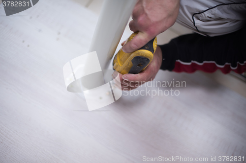 Image of repairman working with drilling machine