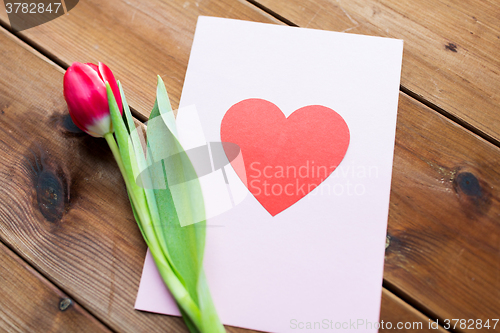 Image of close up of flowers and greeting card with heart