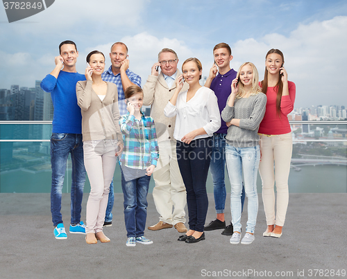 Image of group of smiling people with smartphones