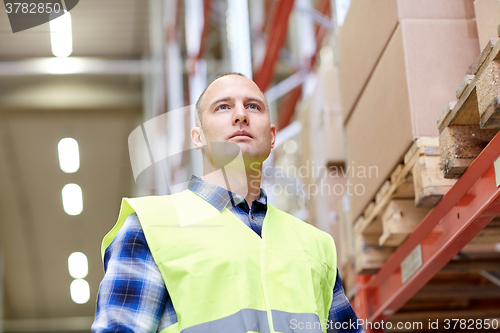 Image of man in reflective safety vest at warehouse