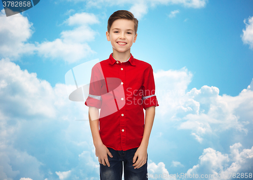 Image of happy boy in red shirt over blue sky