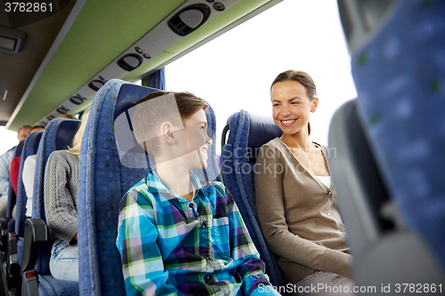 Image of happy family riding in travel bus