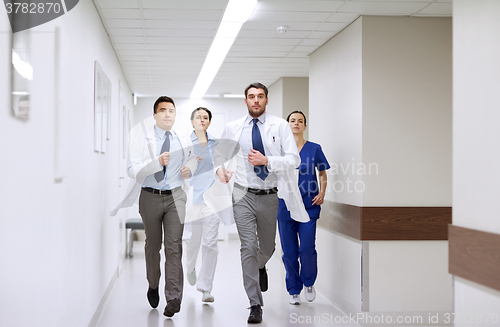 Image of group of medics walking along hospital