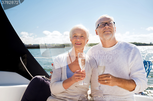 Image of senior couple with glasses on sail boat or yacht