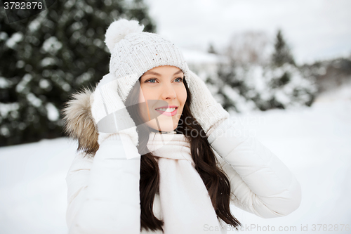 Image of happy woman outdoors in winter clothes