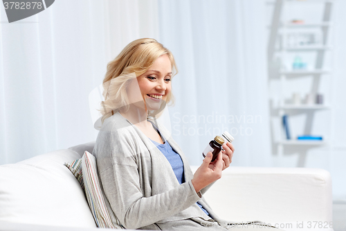 Image of woman with medicine jars at home