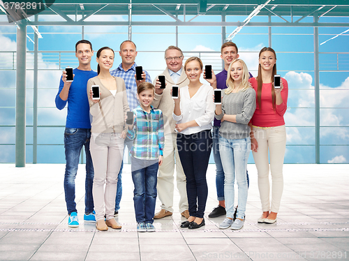 Image of group of smiling people with smartphones