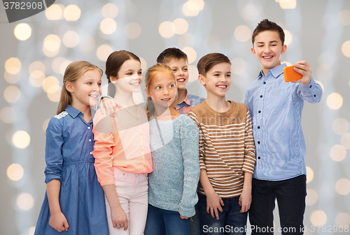 Image of happy children talking selfie by smartphone