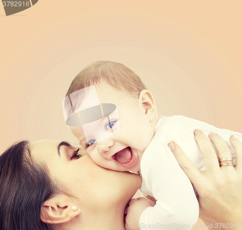 Image of laughing baby playing with mother