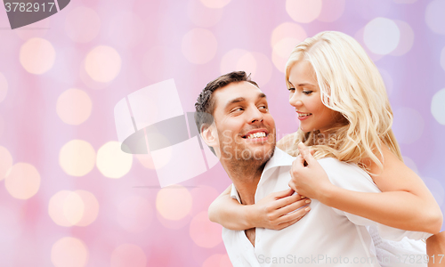Image of happy couple over holidays lights background