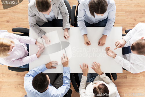 Image of close up of business team sitting at table