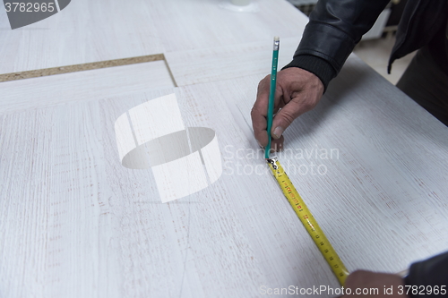Image of carpenter worker measuring
