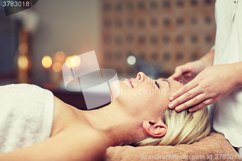 Image of close up of woman having face massage in spa