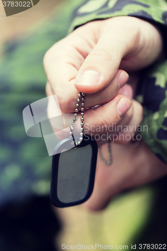 Image of close up of young soldier in military uniform